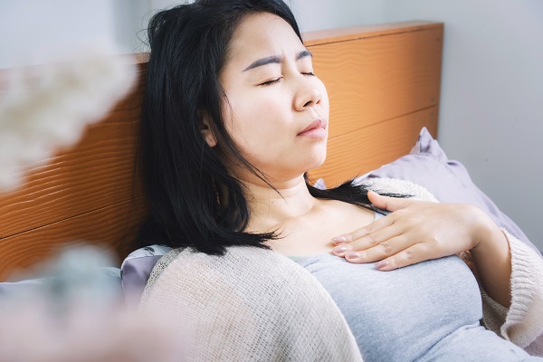 Woman waking up with chest pain