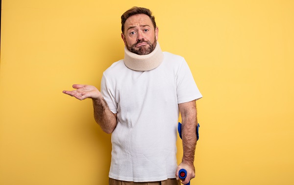 Man in neck brace wondering if maybe he should call a lawyer