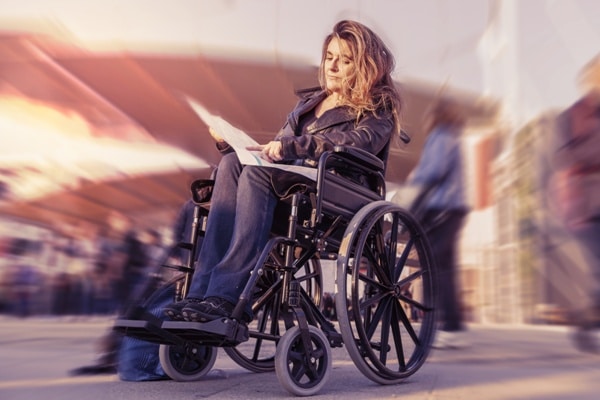 young lady in a wheelchair looking for a destination on map