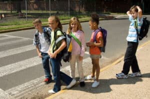 A group of children at a crosswalk