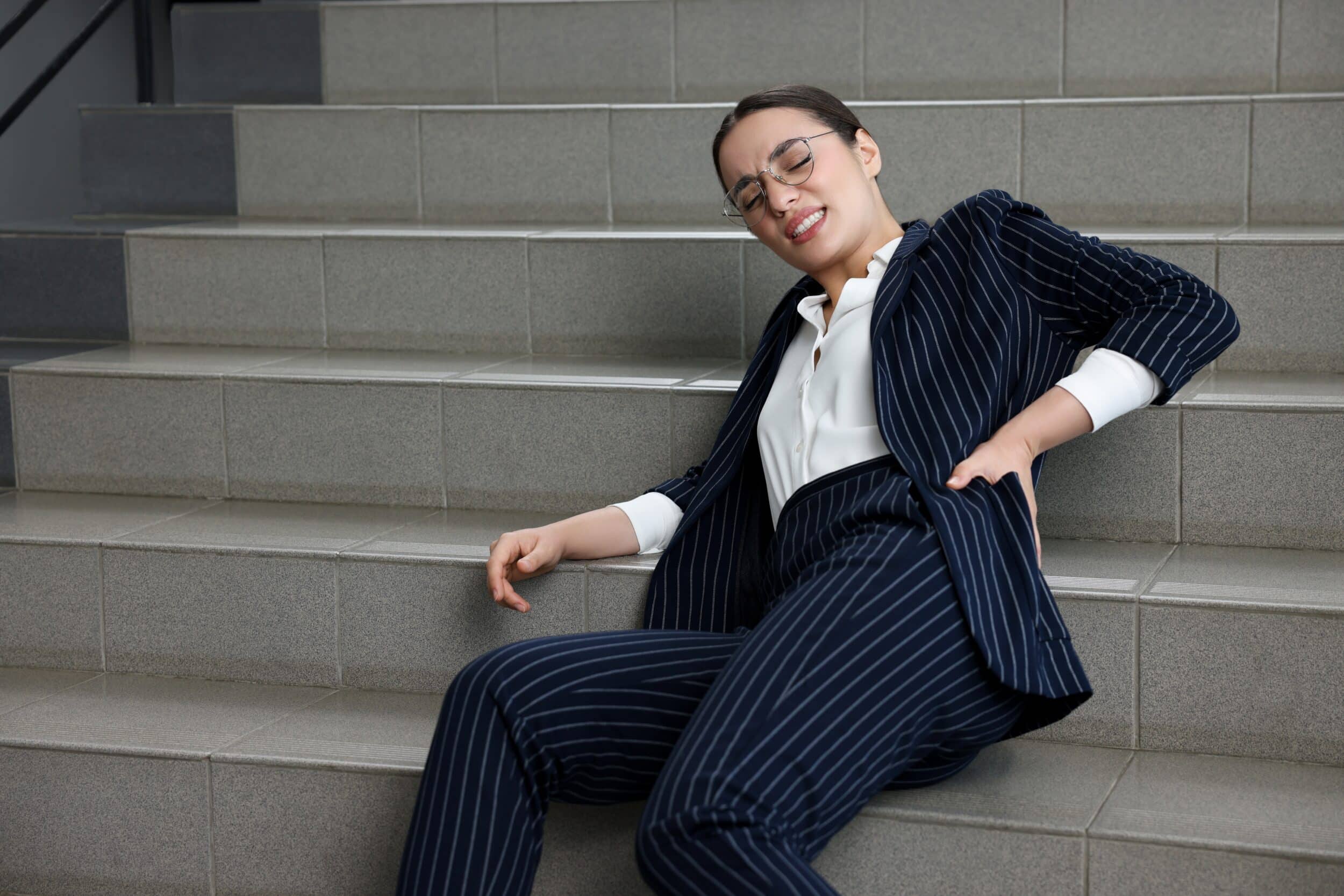 A woman lying on the stairs after a slip and fall accident in Missouri
