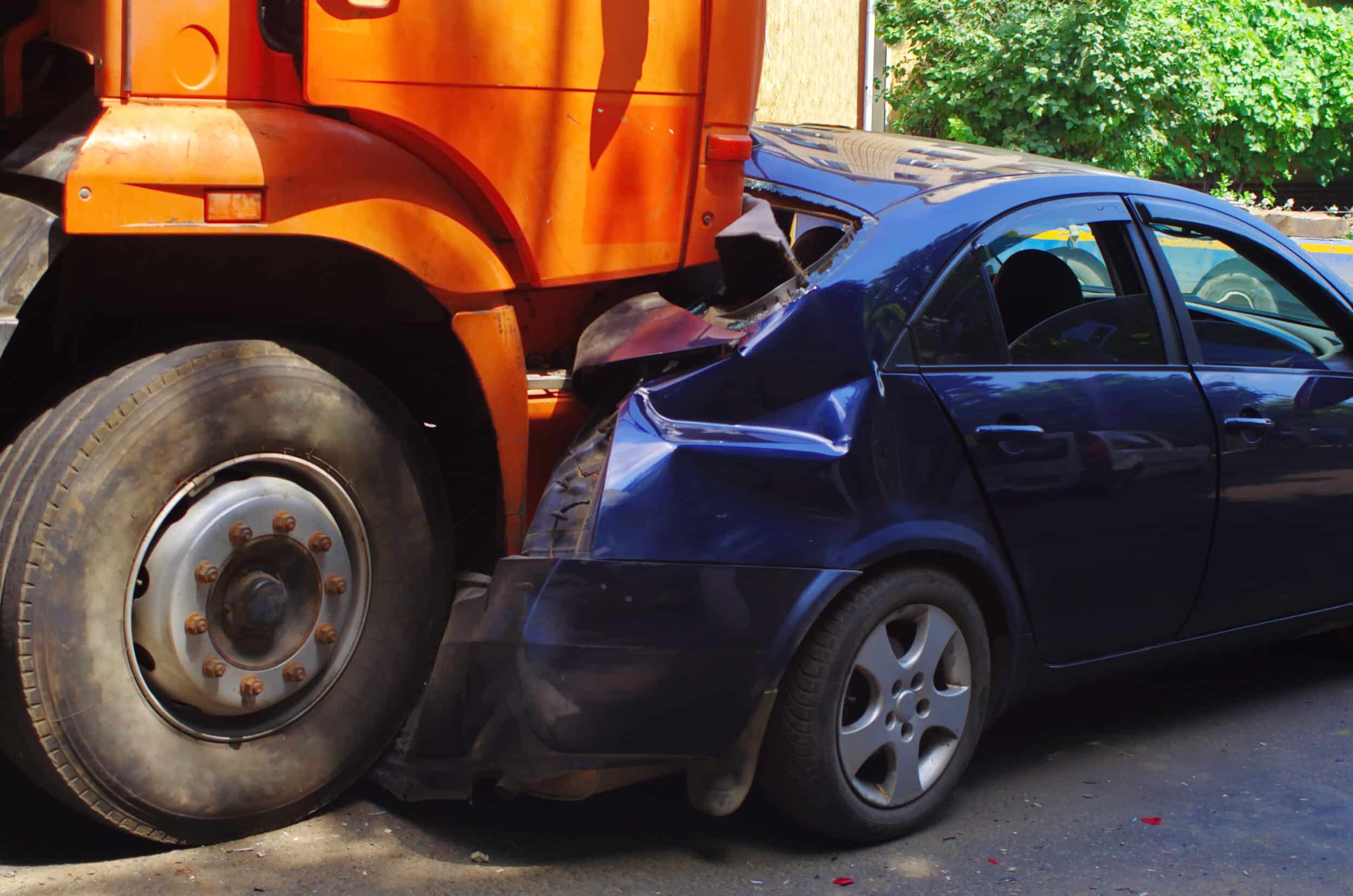 A close-up shot of a collision between a car and truck