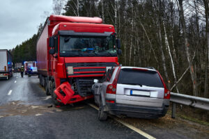Semi-truck and severely damaged SUV at the scene of a commercial vehicle collision.